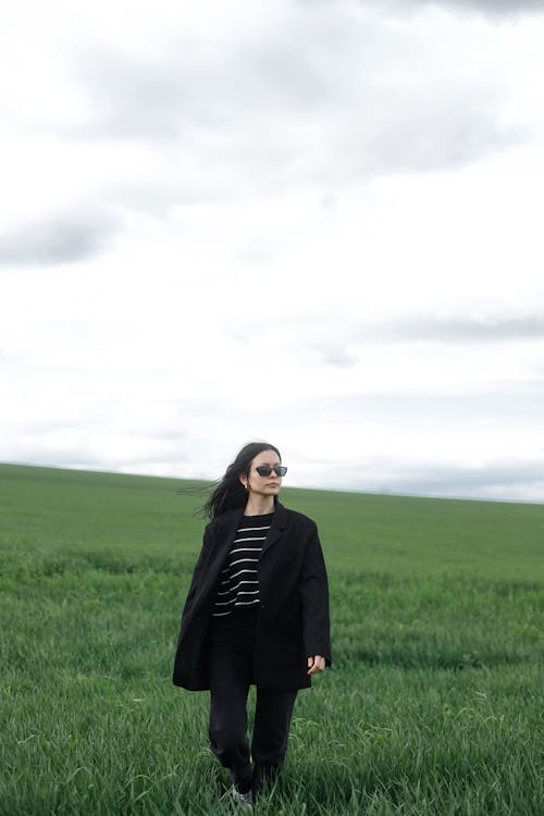 Woman in Black Suit Jacket on Grassland