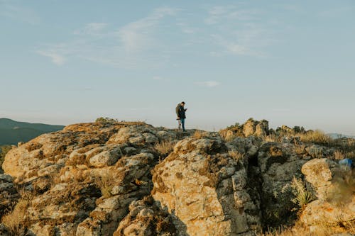 A person standing on top of a rock