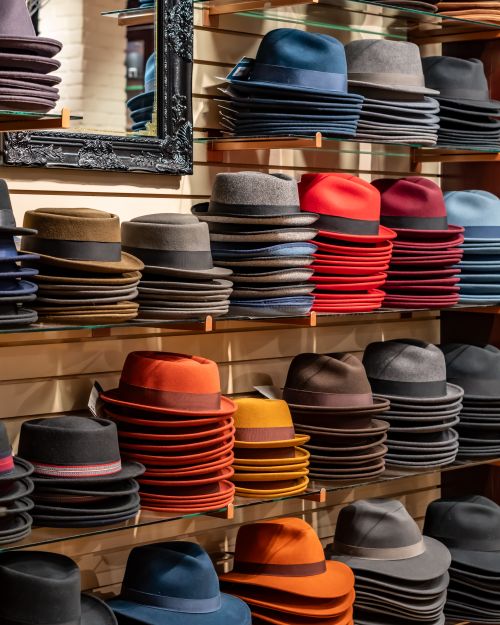 Free Vibrant assortment of hats neatly stacked on shelves in a retail store. Stock Photo
