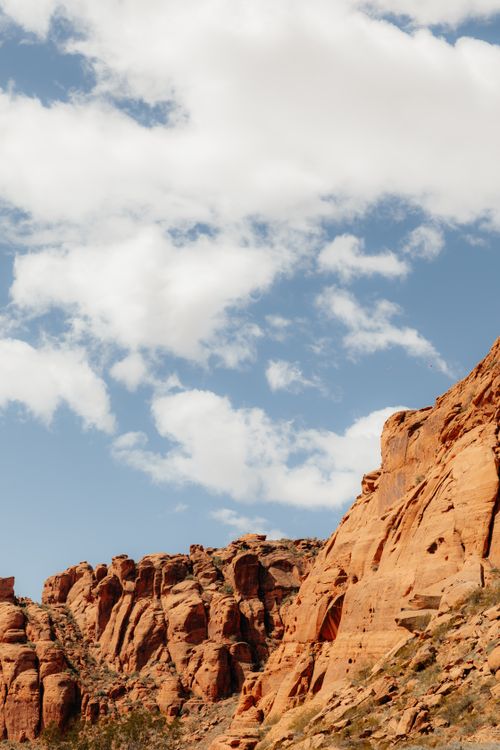 Free Scenic view of eroded red rock formations and clouds in Utah's arid landscape. Stock Photo