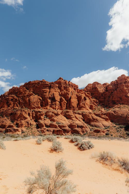 A desert landscape with red rocks and blue sky