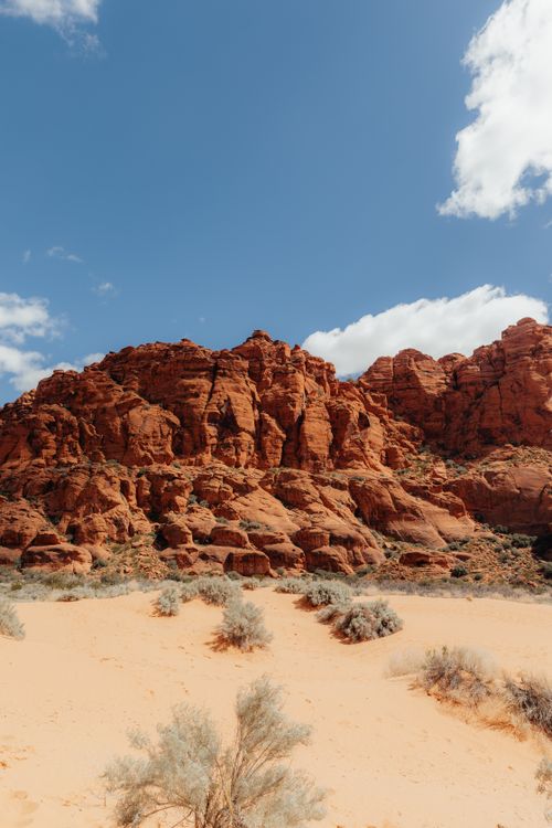 Free Stunning view of red rock formations under a bright blue sky in a desert setting. Stock Photo