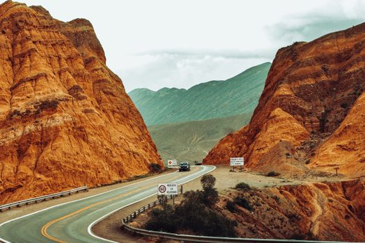 A stunning view of a road winding through Maimara's striking red rock formations in Jujuy, Argentina.