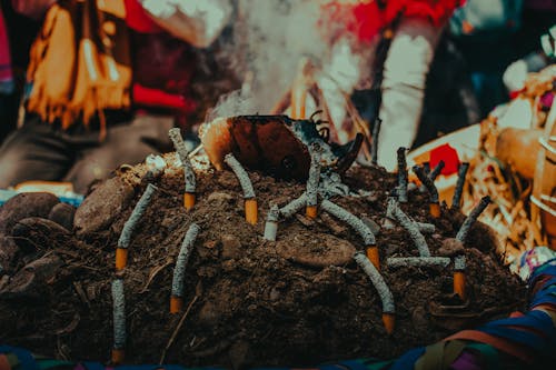 A person is smoking cigarettes on a pile of wood