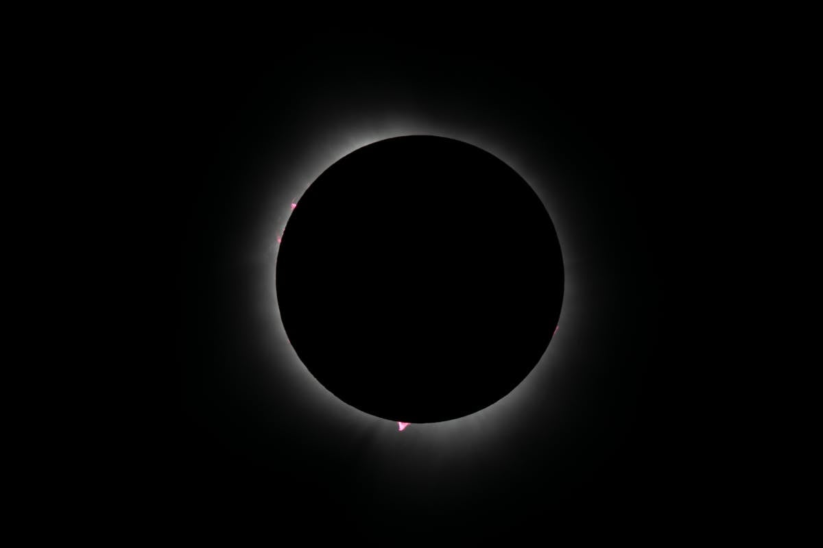 Capture of an annular solar eclipse with glowing corona, showcasing celestial beauty in a dark sky.