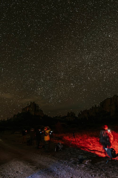 A group of people standing under a starry sky