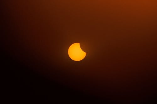 A partial solar eclipse is seen in the sky