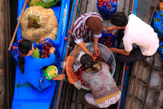 Colorful floating market scene with vendors selling fresh fruits from boats.