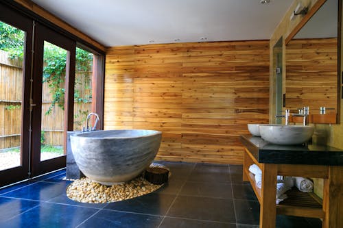 Round White and Gray Ceramic Bathtub Inside Brown Room