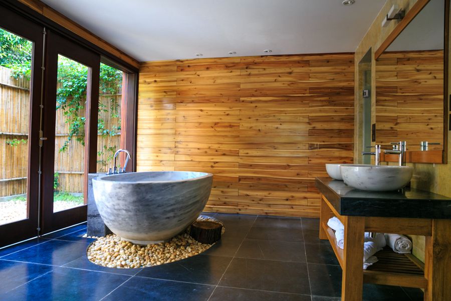 Marble bathroom with round freestanding tub and tiled floor