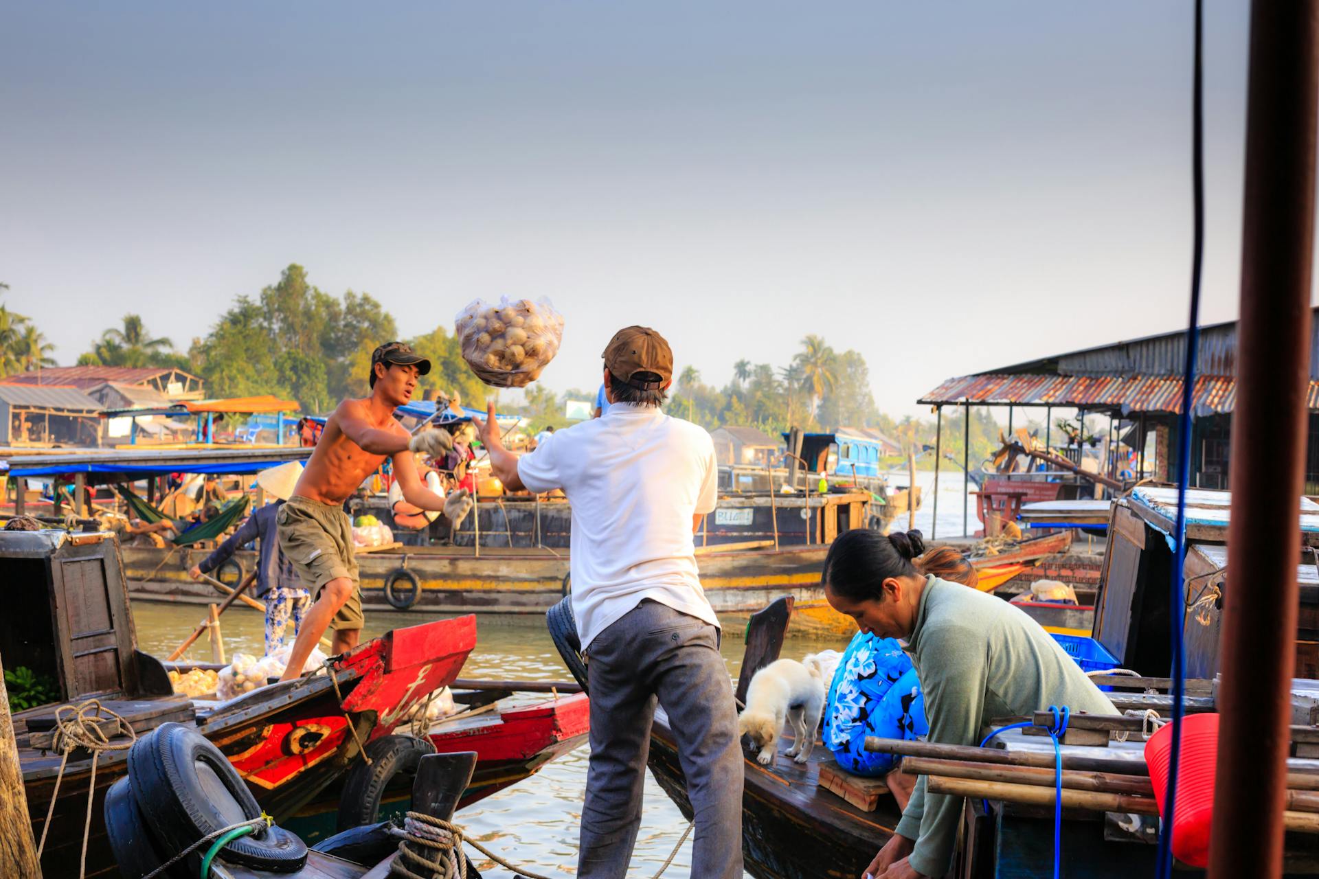 Vibrant scene of a floating market with people trading goods on boats.