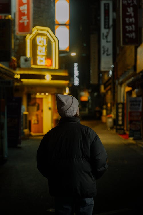 A man standing in the middle of a dark street