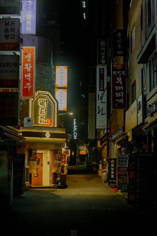 A street with neon signs at night