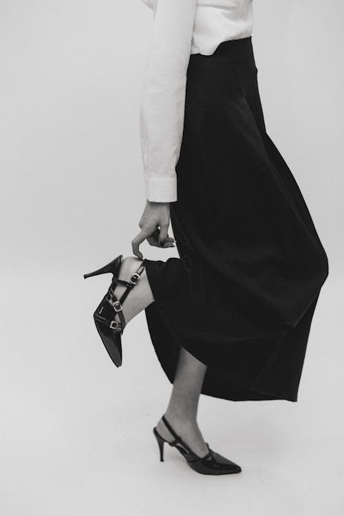 A woman in a black skirt and heels