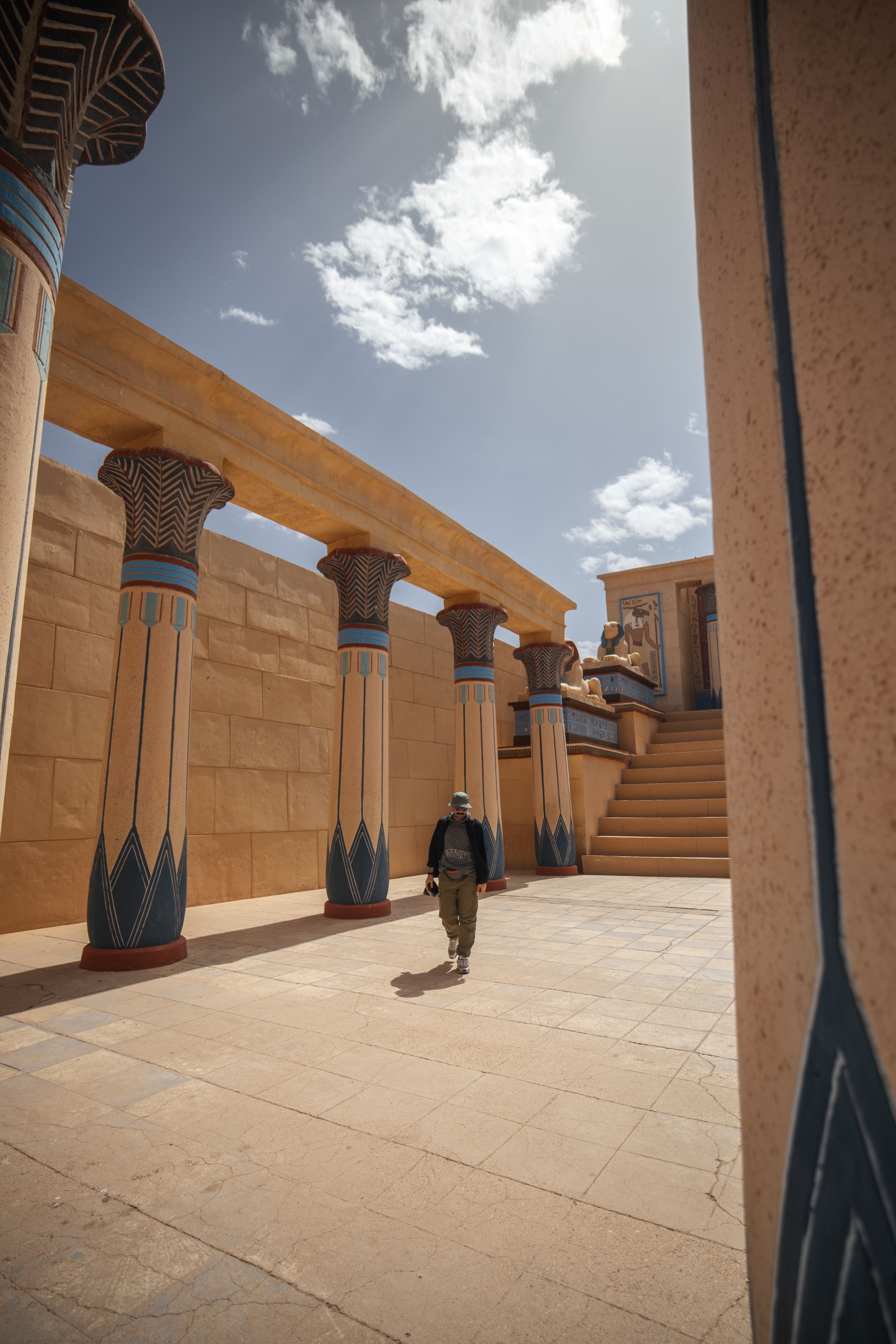 Man Walking near Building Colonnade · Free Stock Photo