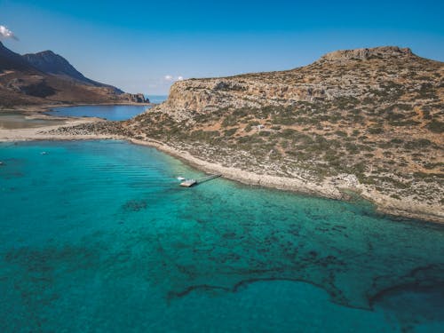 The island of greece is surrounded by turquoise water