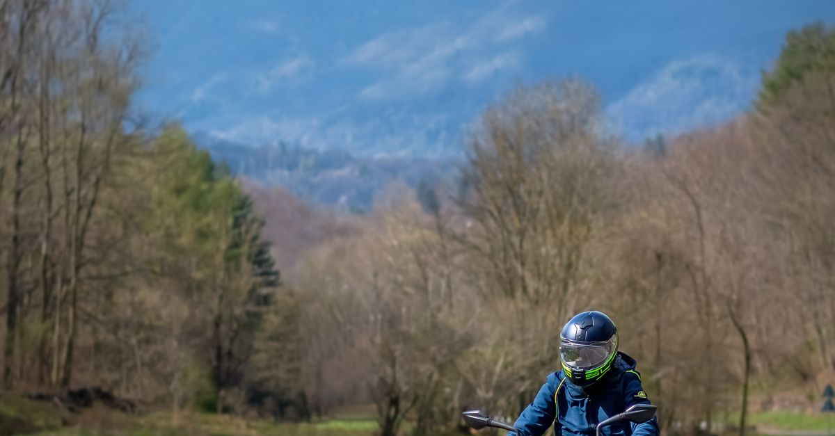 Rural Motorcycle Riding Rider on Motorcycle in Rural Landscape · Free Stock Photo