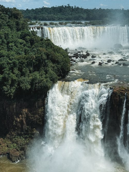 Free Iguazu falls, brazil, is a waterfall that is surrounded by trees Stock Photo