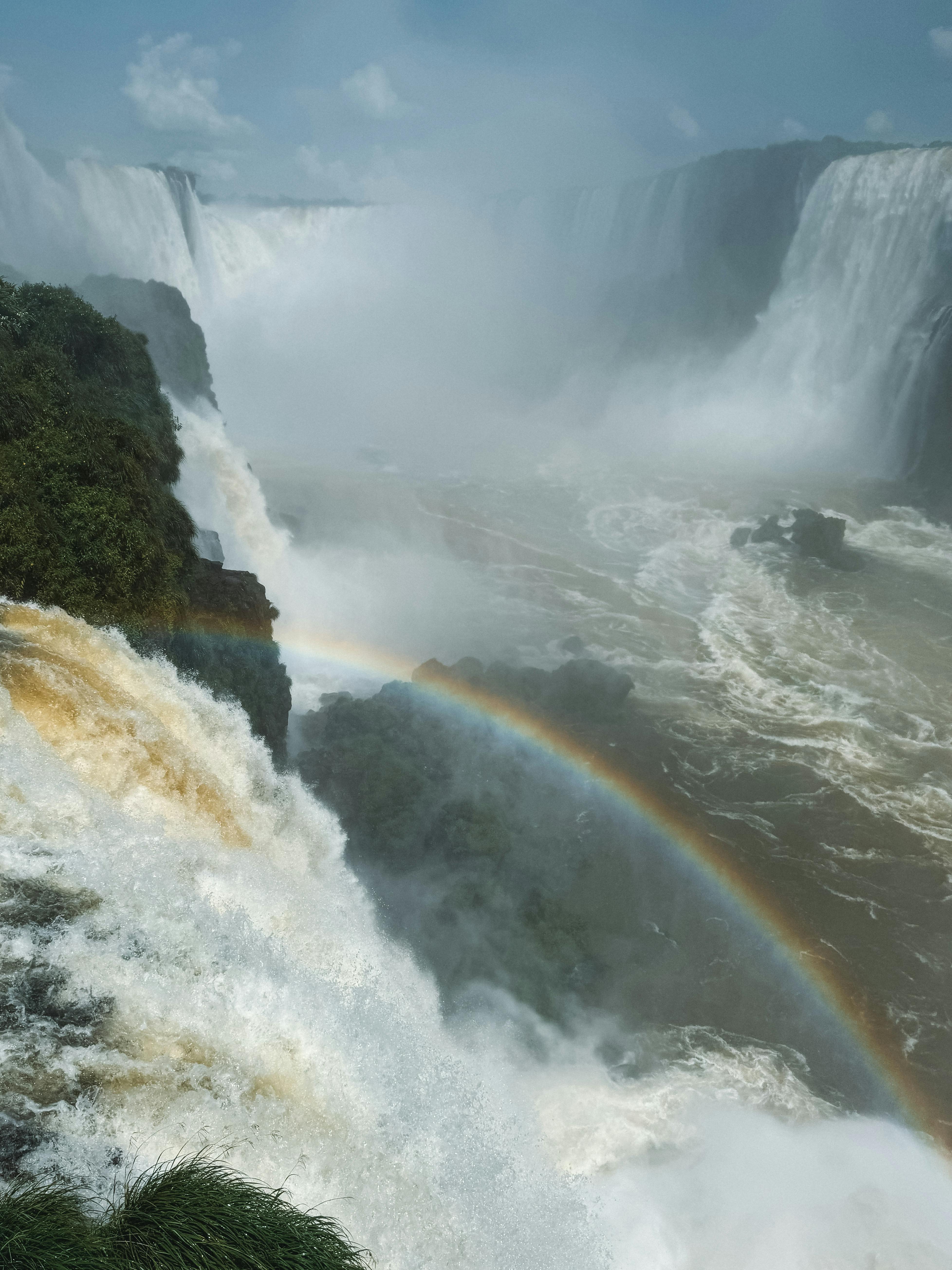 Iguazu Falls captured in full splendor with a bright rainbow, showcasing nature's beauty.