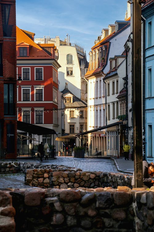 A street with buildings and cobblestone walkways