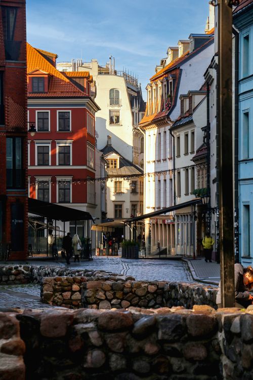 Free Quaint street view of Riga's Old Town featuring colorful historic buildings and cobblestone paths. Stock Photo