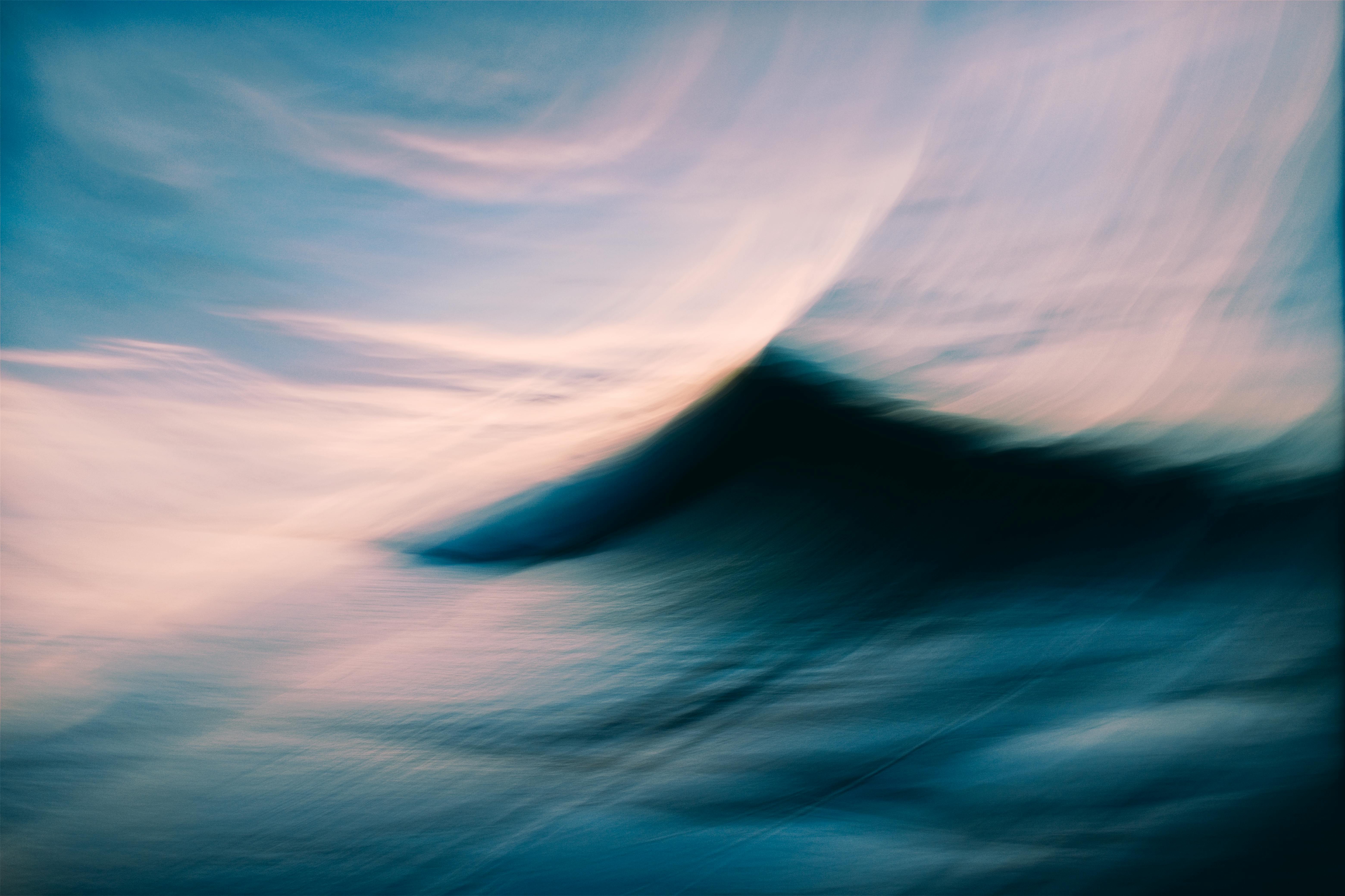 A dreamy abstract view of ocean waves and sky blending at twilight.