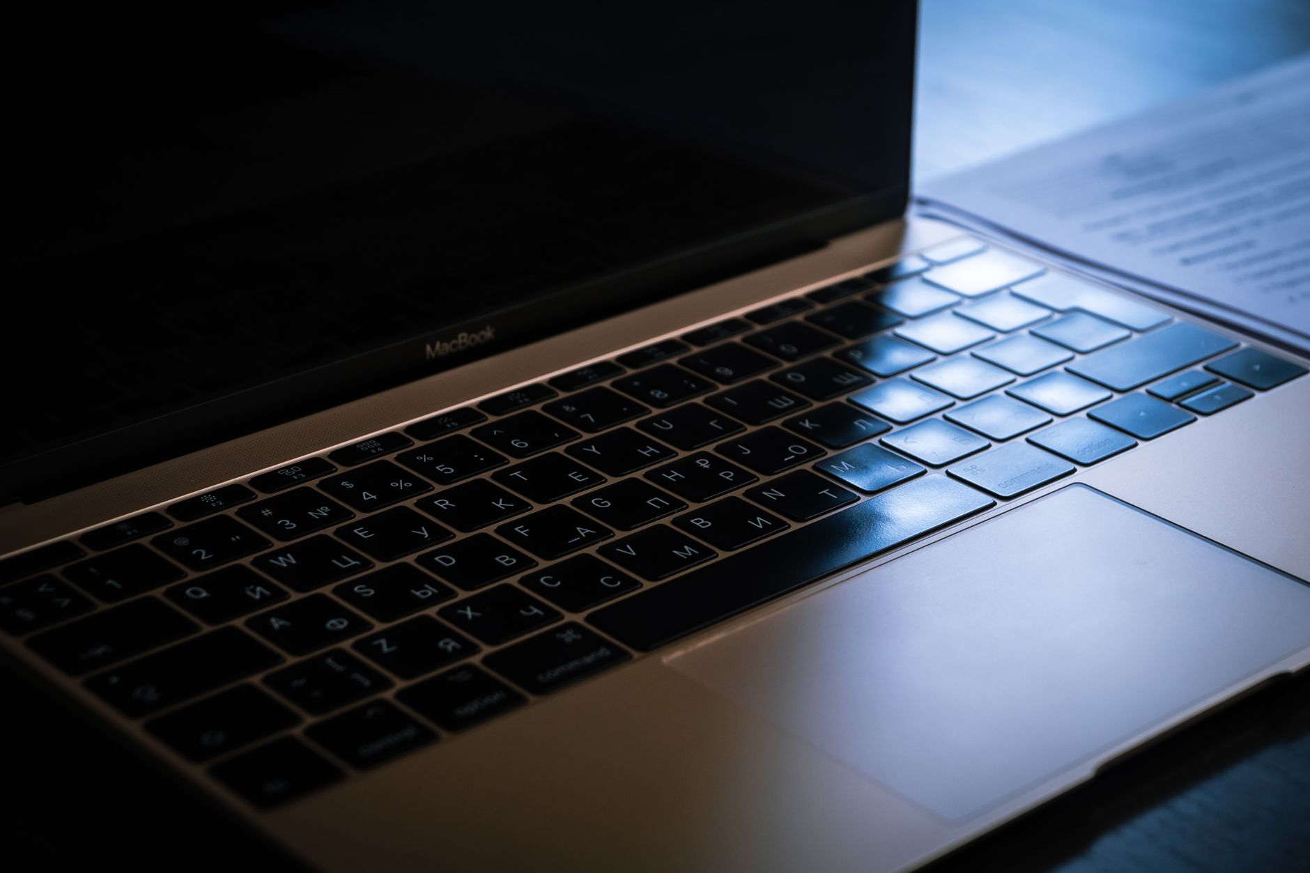 A close-up image showcasing a laptop keyboard with ambient lighting highlighting the keys.