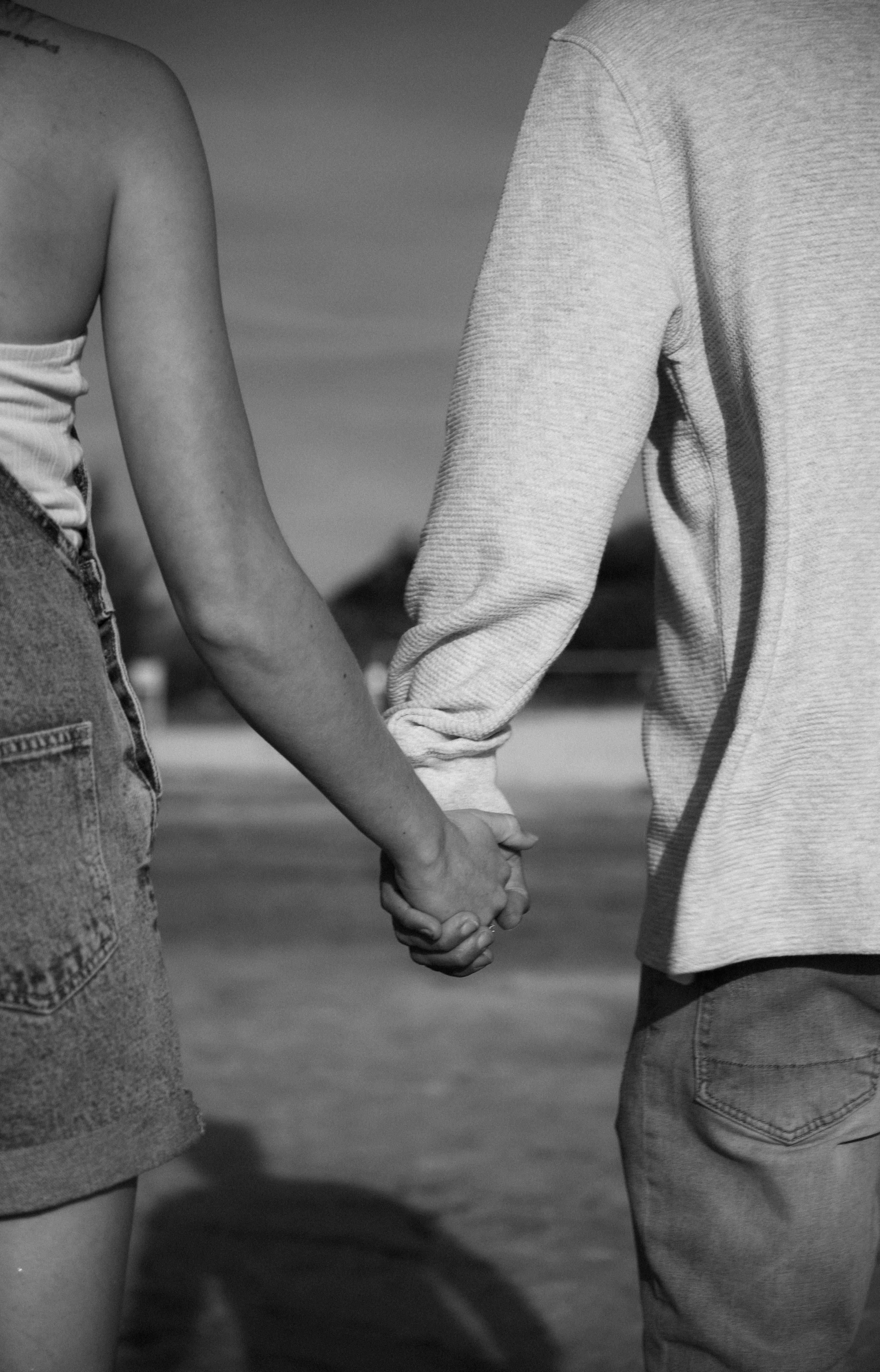 Back View of Couple Holding Hands · Free Stock Photo