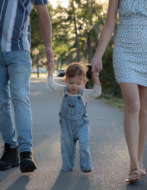 A family walking down a road with a toddler