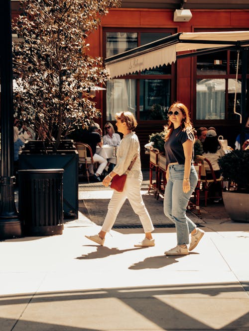 2 women walking in the street 