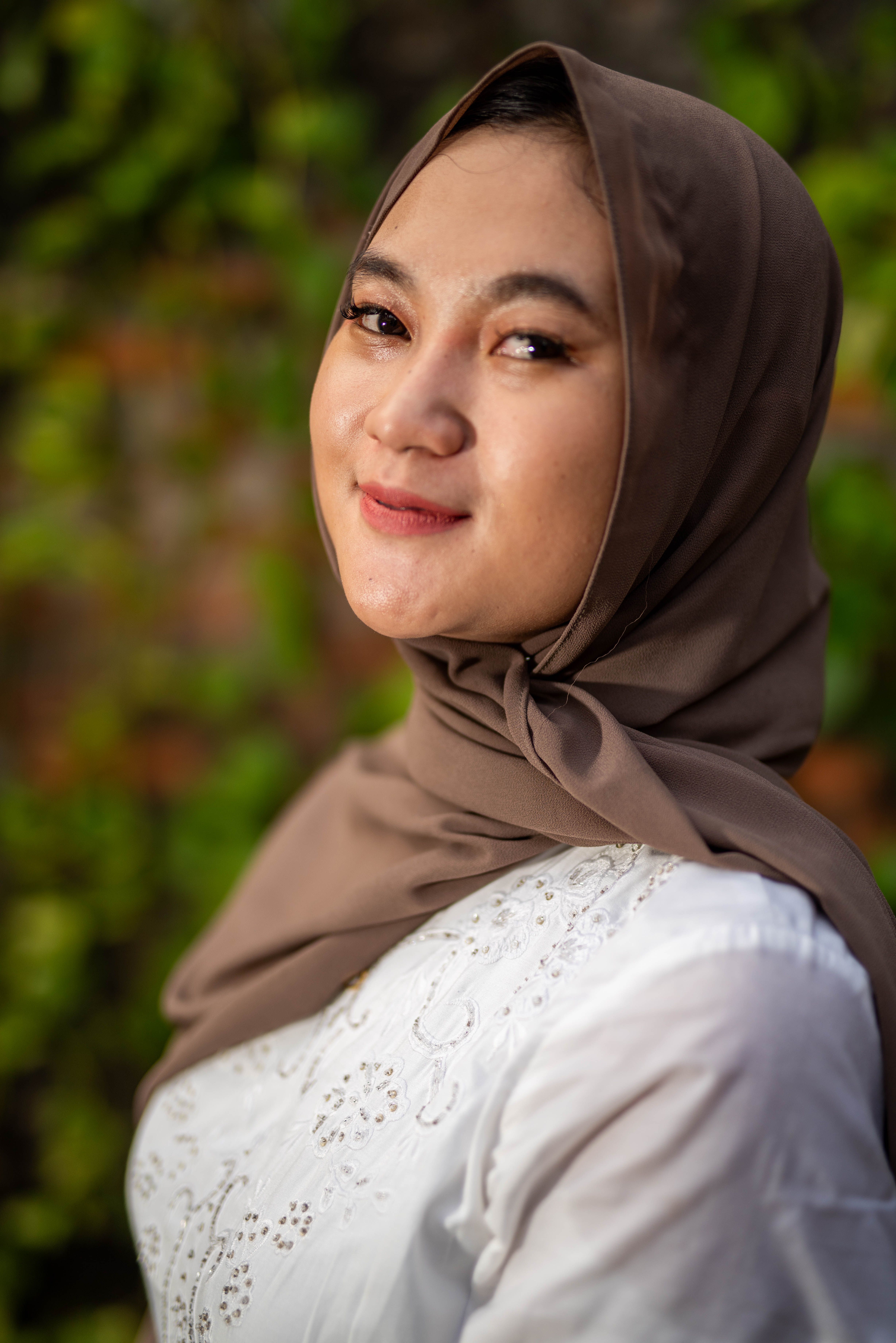 A woman in a brown hijab smiling · Free Stock Photo
