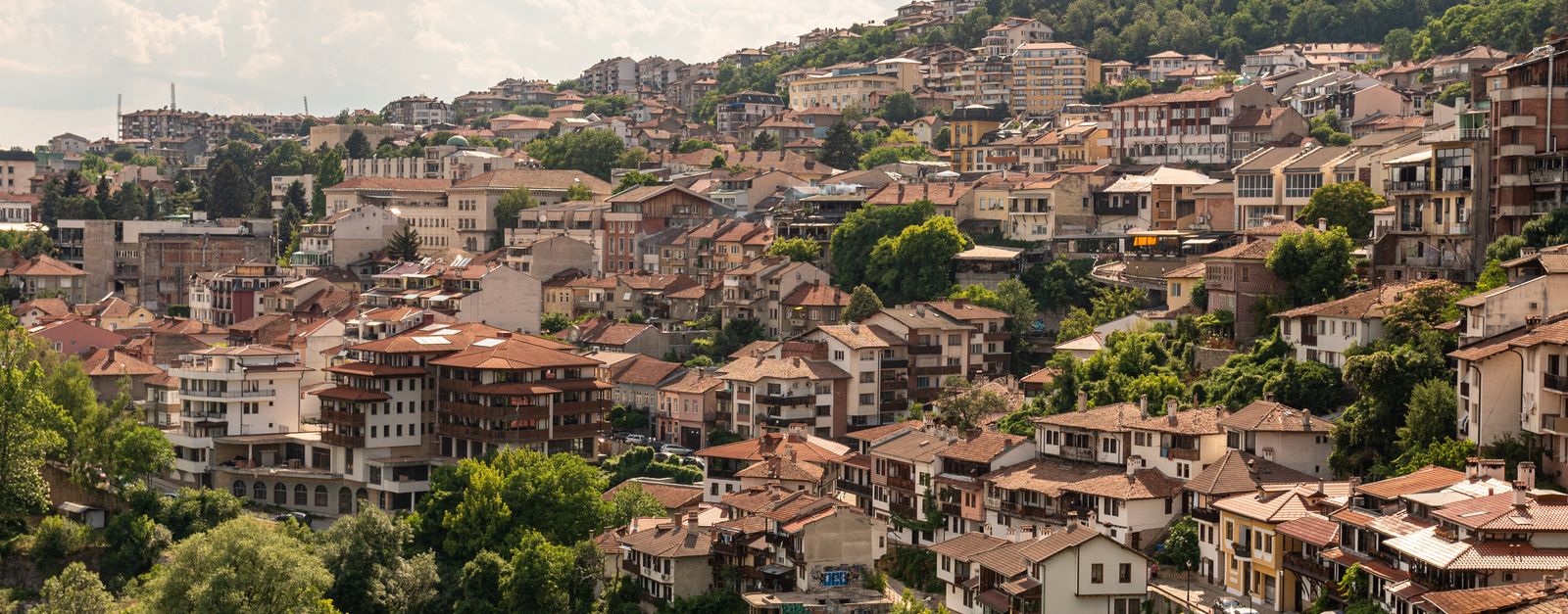 A picturesque aerial view of Veliko Tarnovo, Bulgaria, showcasing its unique architecture and lush greenery.