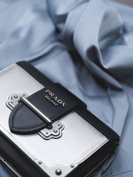 Stylish Prada handbag showcased on luxurious fabric, highlighting elegance and luxury in fashion.