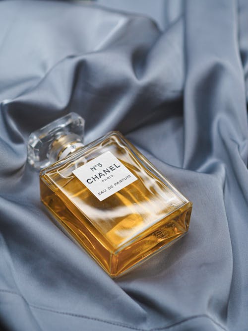 Chanel no 5 perfume bottle on a blue satin sheet