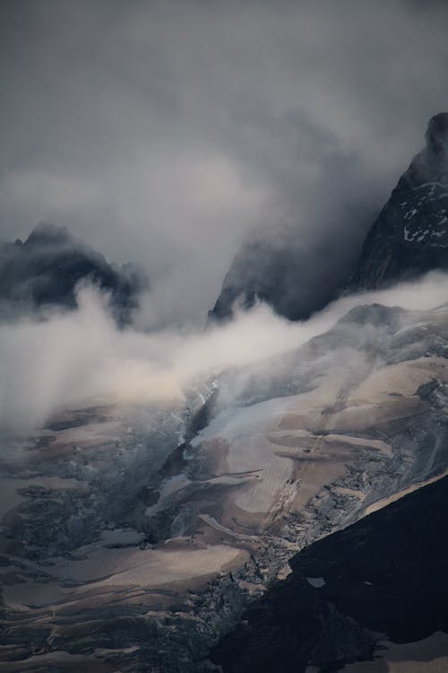 Free A mountain with clouds and snow on it Stock Photo