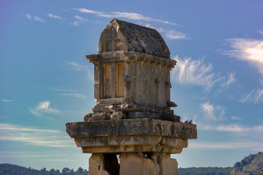 Stone Lycian tomb in Ksantos, Antalya, Türkiye, with clear sky background.