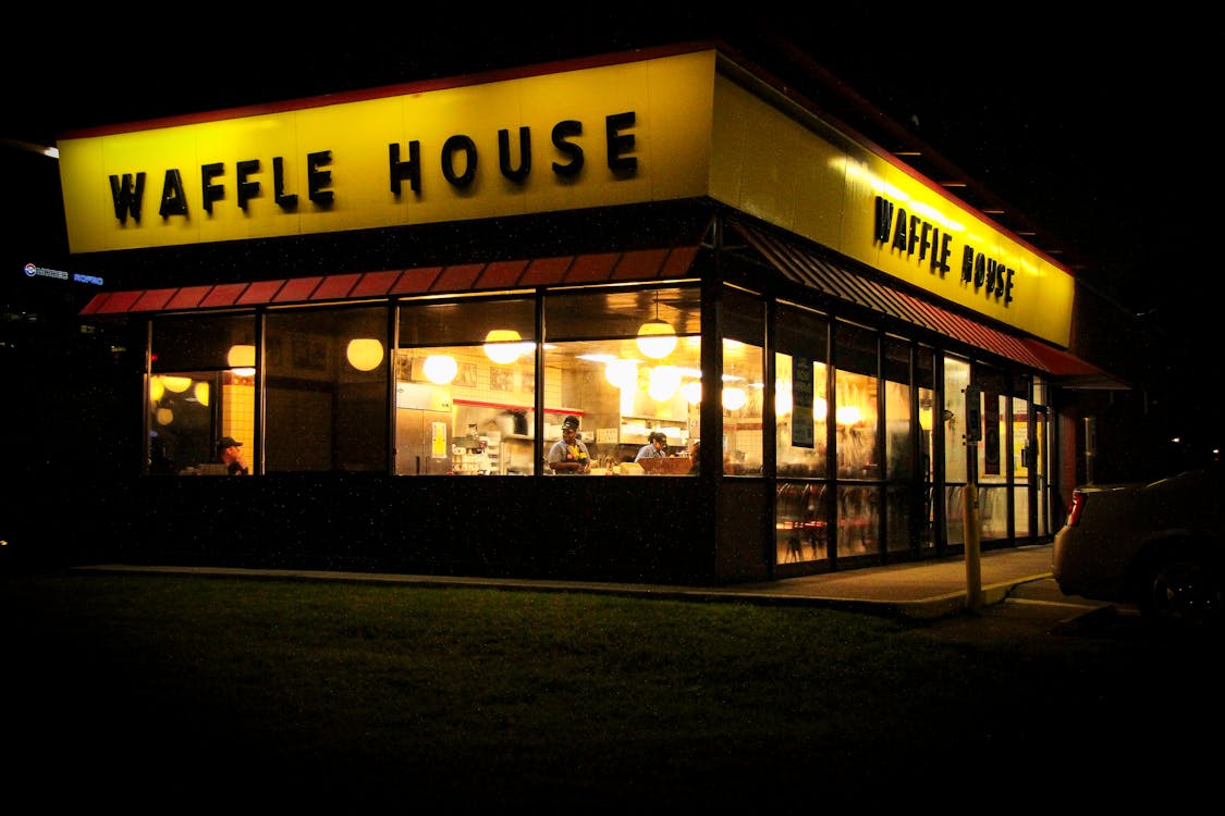 Free Evening view of Waffle House with bright lights in Houston, Texas. Stock Photo