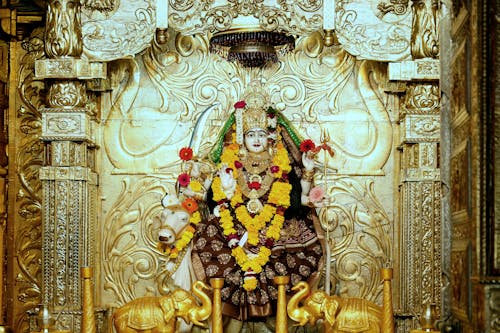 A statue of lord shiva in a gold and silver room