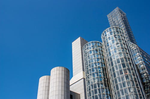 A building with tall glass windows and a blue sky