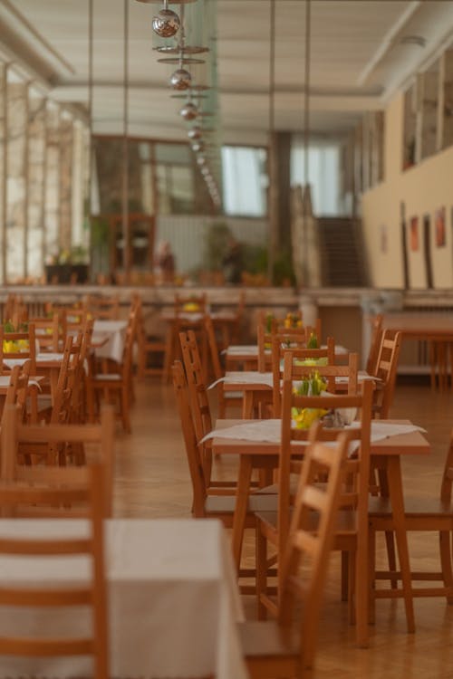 A restaurant with empty tables and chairs