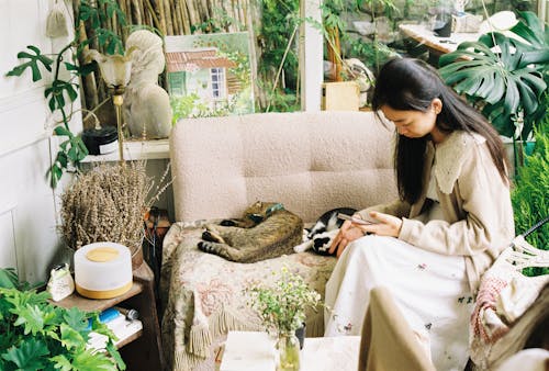 A woman sitting on a couch with a cat