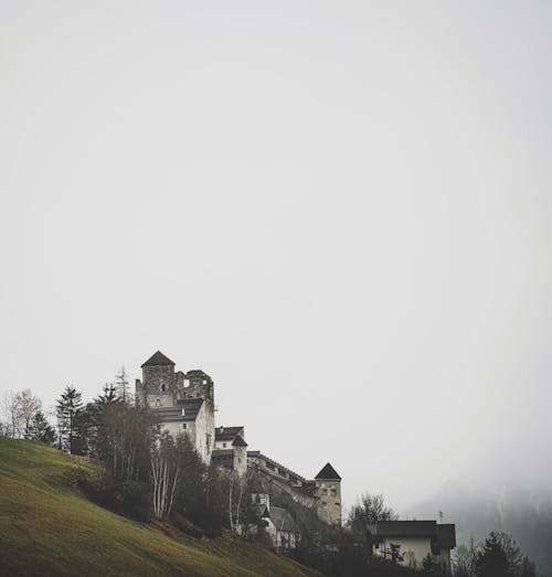 A castle on a hill in the fog