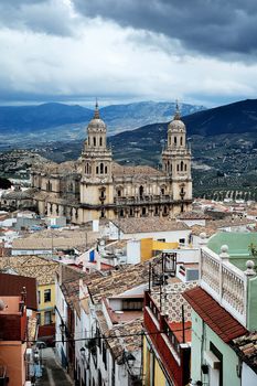 Scenic view of the iconic Jaén Cathedral with town and mountain backdrop.