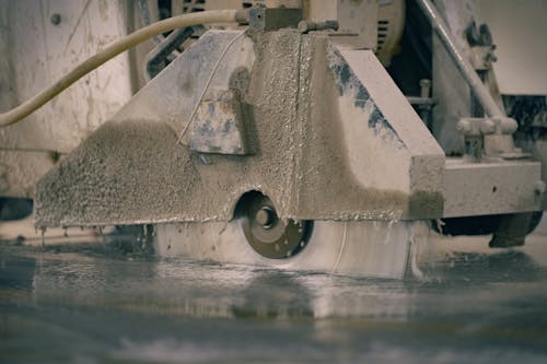 A cement floor being cut with a machine