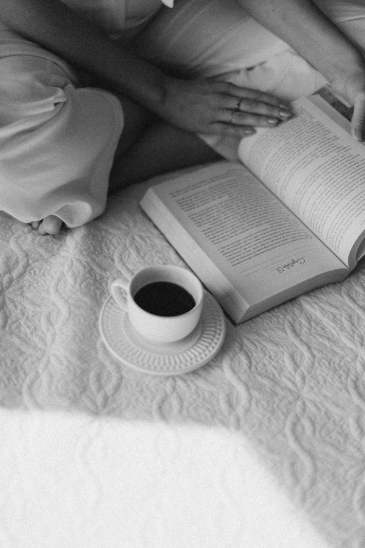 Woman Sitting With Book And Coffee Cup