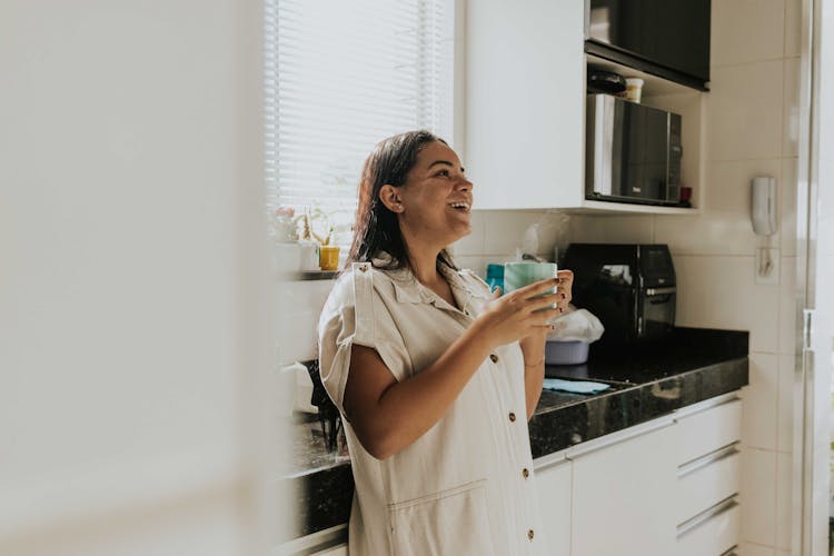 Smiling Woman Standing With Hot Drink