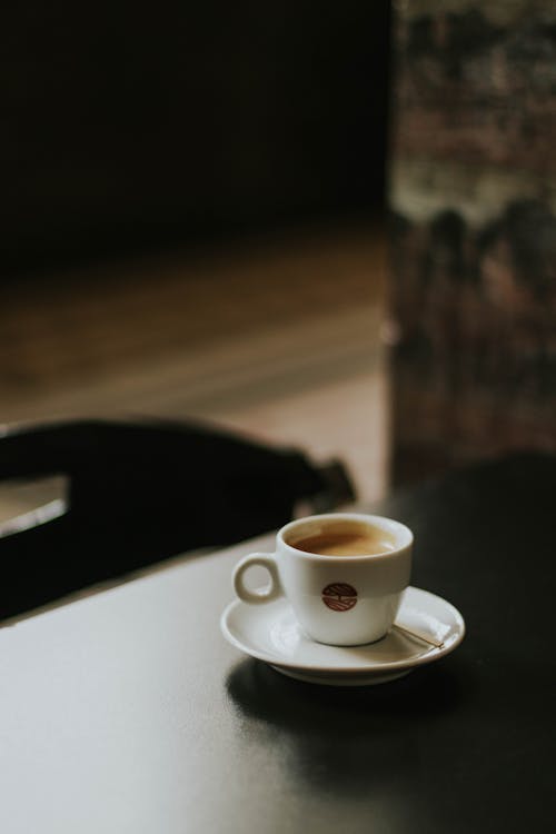 Free A cup of coffee sits on a table Stock Photo