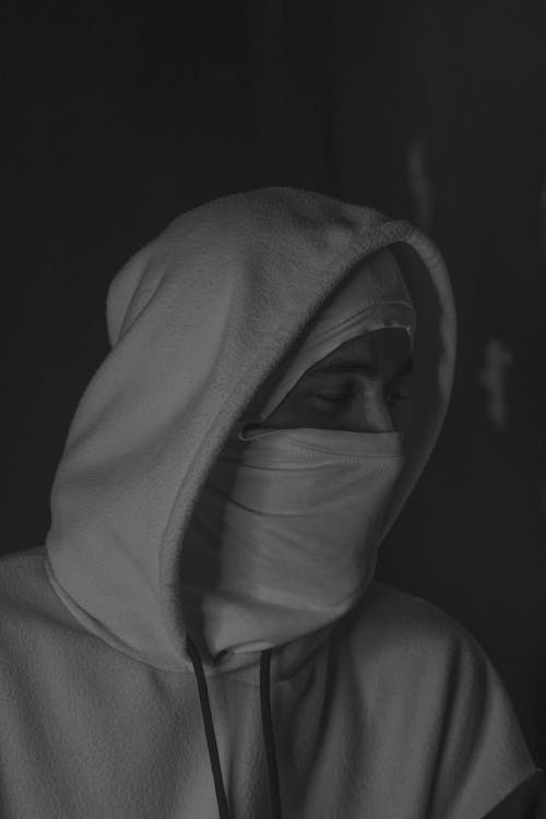 Free A black and white photo of a person wearing a hoodie Stock Photo