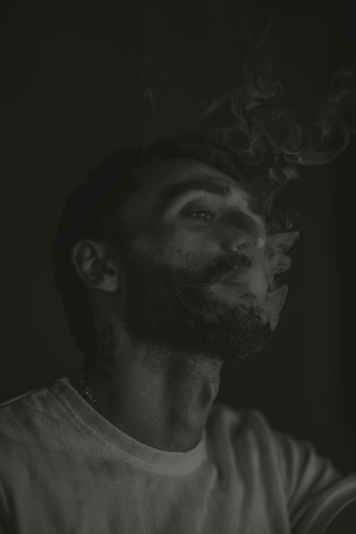A man smoking in black and white