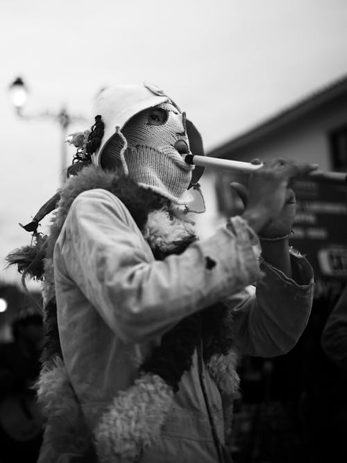 Person in Balaclava Playing Flute